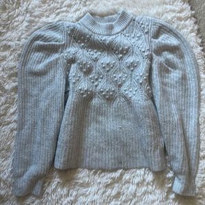 Women’s mock turtle neck. Sits right below waist and has puffed sleeves.